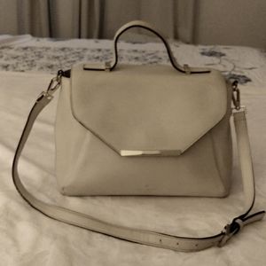 Ladies elegant handbag, tan in color, and made by Kate Spade.